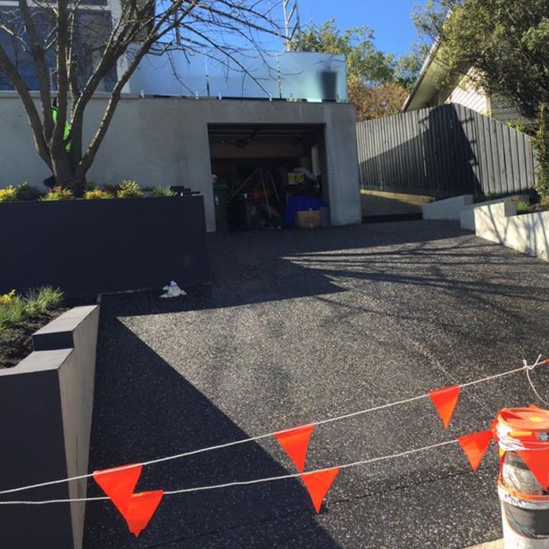 Driveway with exposed aggregate finish protected to prevent accidental damage